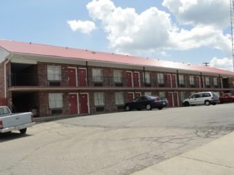 Two storey hotel building with parking spaces